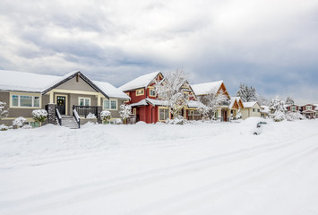 A perfect neighborhood. Houses in suburb at snow winter in the north America.