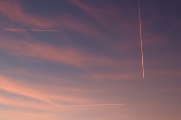 plane in sunset sky