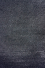 dark surface of stucco wall with traces of processing.