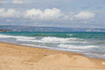 The sea coast of Bulgaria is a sandy beach with Golden sand and rocky high banks with tiled roofs of houses. The Balkan coast, the sea in Sozopol