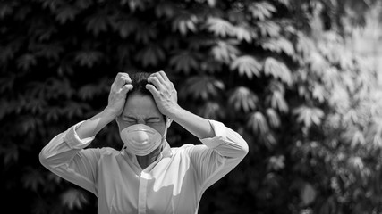 Asian girl feeling the strain and wearing a mask.  - Protection against virus, infection, exhaust and industrial emissions.