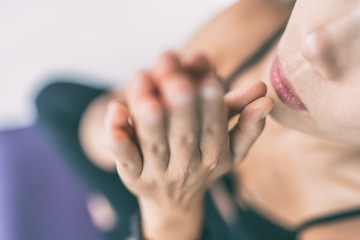 Meditation mantra woman praying with hands at mouth chakra saying zen prayer meditating at yoga...