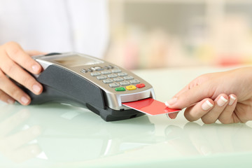 Client paying with credit card reader in a pharmacy