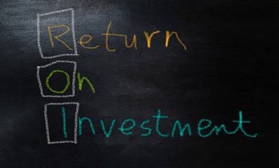 ROI acronym hand writing on chalkboard, Return On Investment