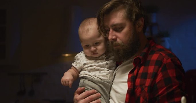 Father Feeding A Baby At Night