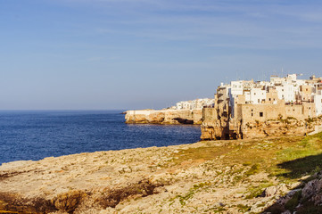 Fototapeta na wymiar Small town on the coast line of Mediterranean sea with blue sky on the background