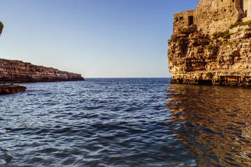Fototapeta na wymiar Rocks in the water on a sunny day with a horizon on the background