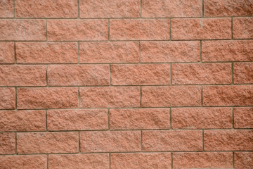 Texture of grungy pink brick on the wal