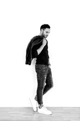 Naklejka premium Handsome model in the studio. Pretty man with jacket. Fashion shooting.