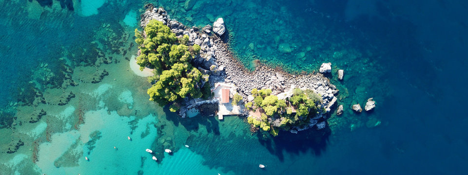 Aerial drone of paradise small islet with landmark chapel of Panagia in picturesque village of Parga, Ionian, Greece