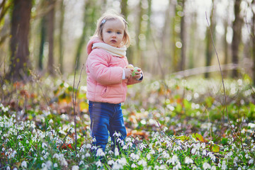 Cute little girl playing egg hunt on Easter