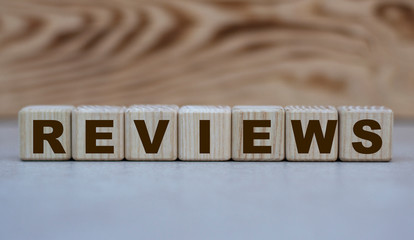 concept word reviews on cubes on a beautiful wooden background