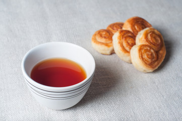 Tea mug and fresh pastries. Light morning breakfast. Fresh homemade cakes