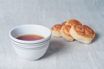 Tea mug and fresh pastries. Light morning breakfast. Fresh homemade cakes