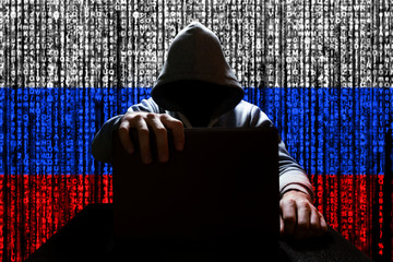 Russian hacker closes the lid of the laptop, against the backdrop of a binary code, the color of...