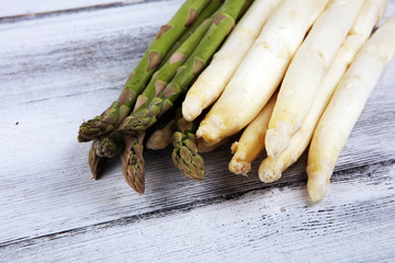 White and green asparagus on rustic background.