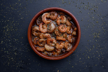 Garlic ranges, typical and traditional dish of Spain, served and made in a mud rate