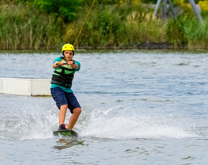 Teenager wakeboarding on a lake - Brwinow, Masovia, Poland