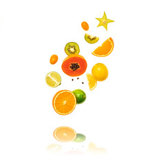 Fresh fruits flying in air. Papaya, orange, kiwi, lemon isolated on white background. Healthy fruity vegan tropical mix background. Colorful levitation, falling fly fruit creative concept