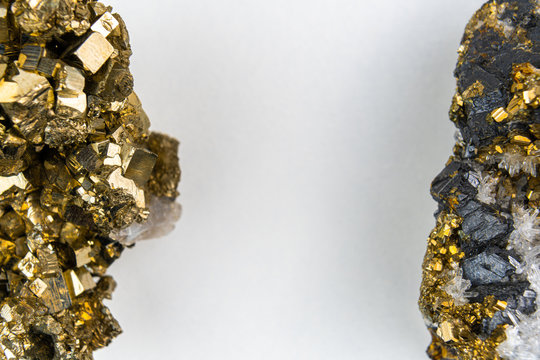 Closeup of two golden colored Pyrite mineral with space between