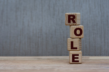 concept word role on wooden cubes on a gray background