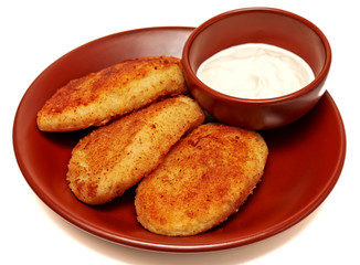 Potato fried meatballs with meat and sour cream on a white background