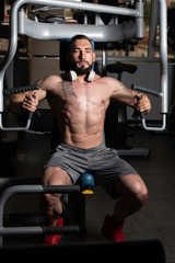 Fototapeta na wymiar Bodybuilder Exercising Chest On Machine