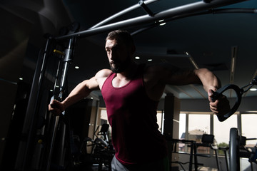 Fototapeta na wymiar Muscular Man Exercising Chest