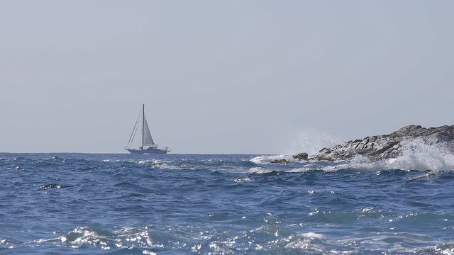 Beautiful seascape of Spanich Costa Brava in Catalonia, in the distance a sailboat