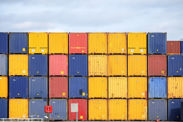 Colorful freight containers stacked up on the quay for shipping in the cargo port