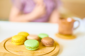 Amazing woman in a purple silk robe drinking coffee early in the morning in bed. Wooden cup of latte on the white tray. Breakfast concept