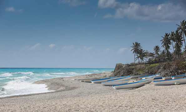 dramatic image of fishing boats on the caribbean coast in Los Patos, dominican republic.