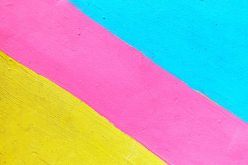 Abstract texture of plaster light blue and yellow with pink-colored line.