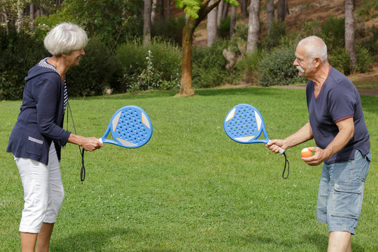 portrait of senior couple playing tennis