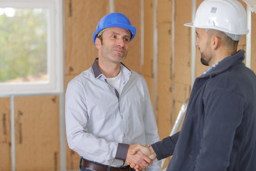 customer shaking hands with builder