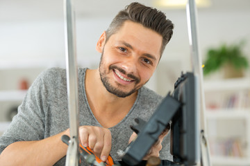 positive young man with tools