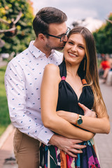 Obraz premium the guy hugs and kisses the girl. girl with gentle makeup smilin