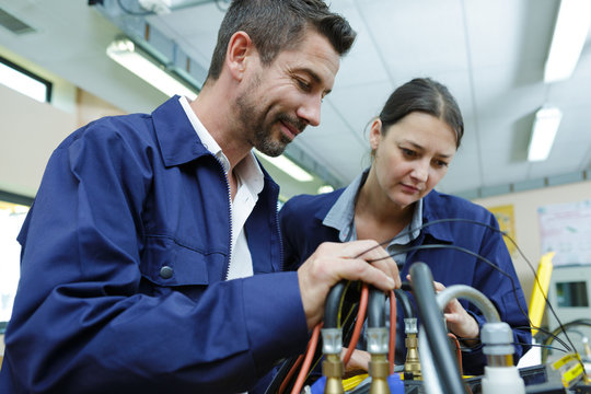 painter and electrician standing side by side