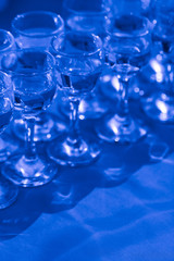 Elegant water glasses, close up, top view, toned in classic blue.
