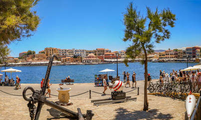 CHANIA, CRETE ISLAND, GREECE - JULY 12, 2019: Kucuk Hasan Pasha Mosque and old Venetian Harbor promenade, beautiful historical buildings at Akti Tompazi street.