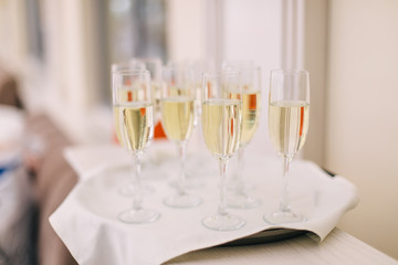 champagne glasses on white tape