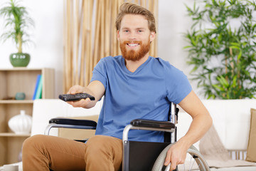 happy handicap man watching television in living room
