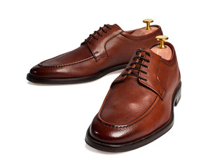 Isolated brown male shoes on white background.