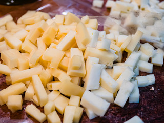 Close-up of the typical cheeses used in the recipe for making Pizzoccheri. Typical dish from Valtellina, Lombardy, Italy.