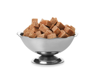 Metal bowl with brown sugar cubes isolated on white