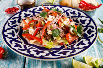 Fresh salad with beef, herbs and red pepper.