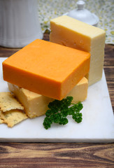 Leicestershire cheese or red leicester and mature cheddar, variety of British hard cheeses made from cow milk