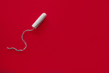 Medical female swab on a red background, top view, female menstruation, blood absorbent, critical days, female accessory