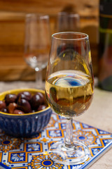Fortified wine from Andalusia, Spain, different types of sherry in glasses and olives, colors of Andalusisa