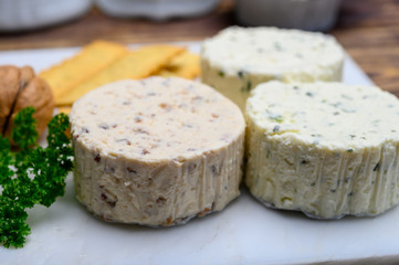 Spread cream cheese with herbs, garlic, chives and spices close up